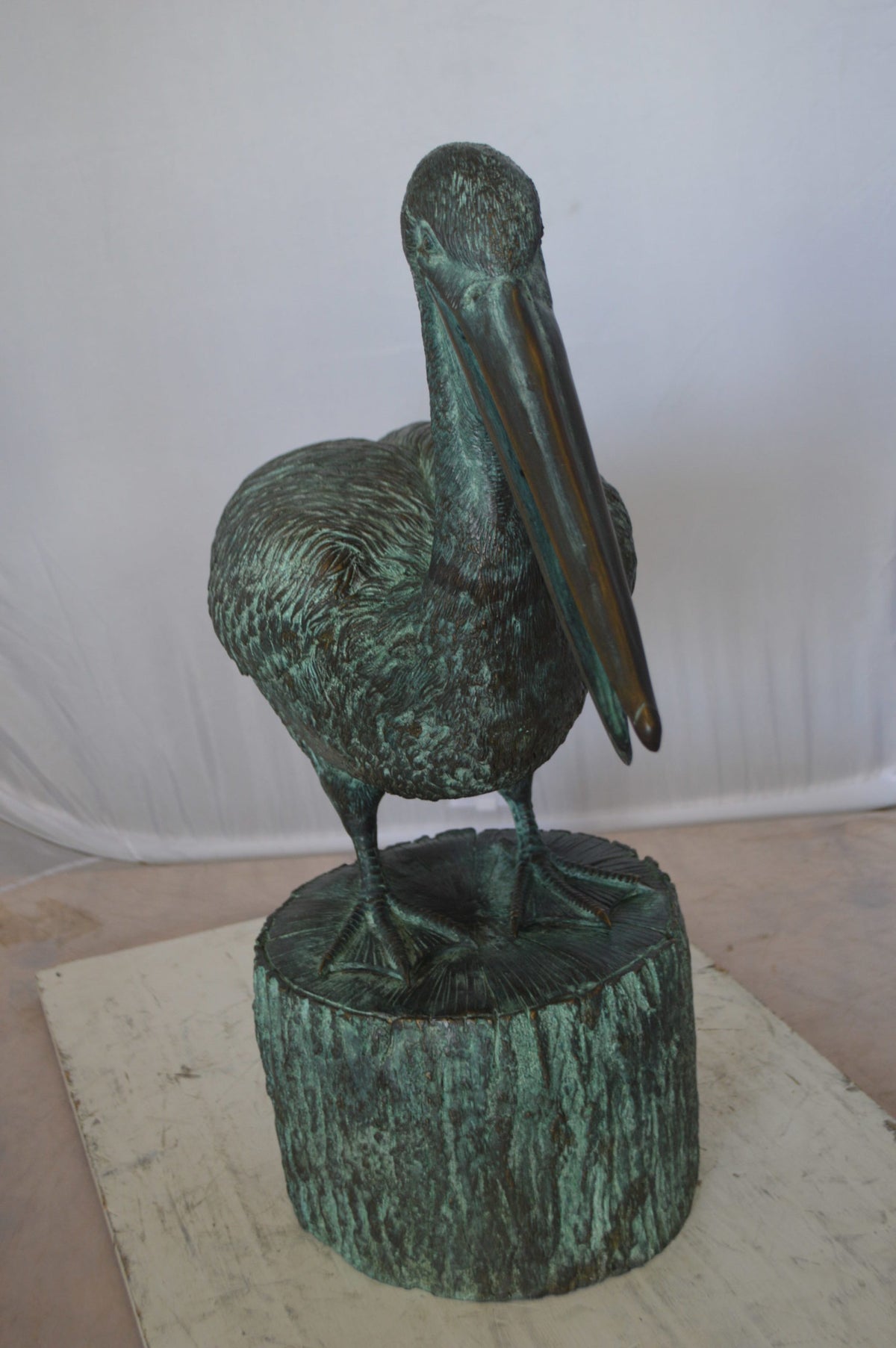 Nifao Pelican on a Tree Stump fountain bronze statue - Size: 30"L x 16"W x 46"H.